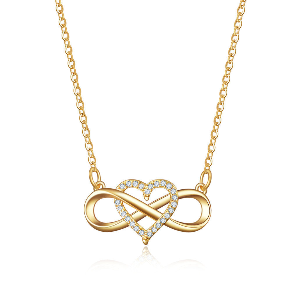 Close-up of the gold infinity sign woven through a stone-set heart