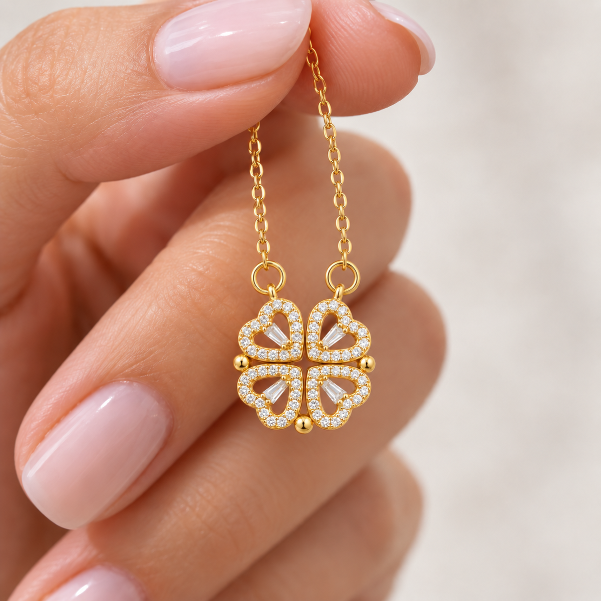 Close-up of the gold stone-set four leaf clover pendant