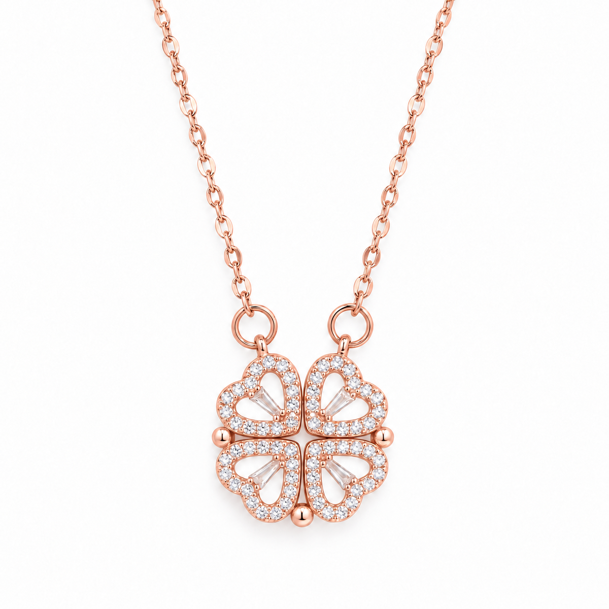 Rose gold four leaf clover heart necklace on a white background