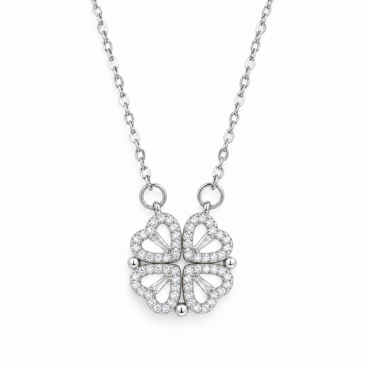 Silver four leaf clover heart necklace on a white background