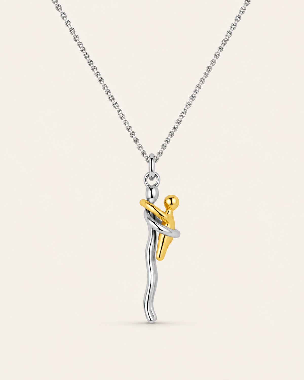 Mother and child necklace with a silver mum holding a gold baby