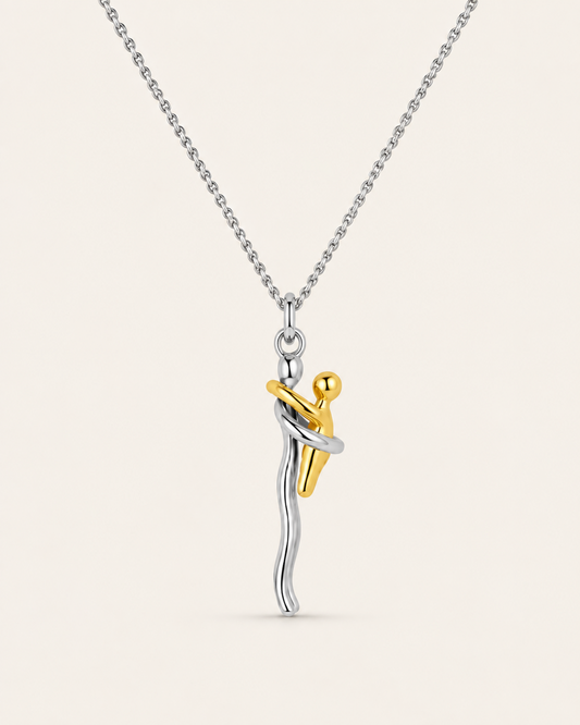 Mother and child necklace with a silver mum holding a gold baby