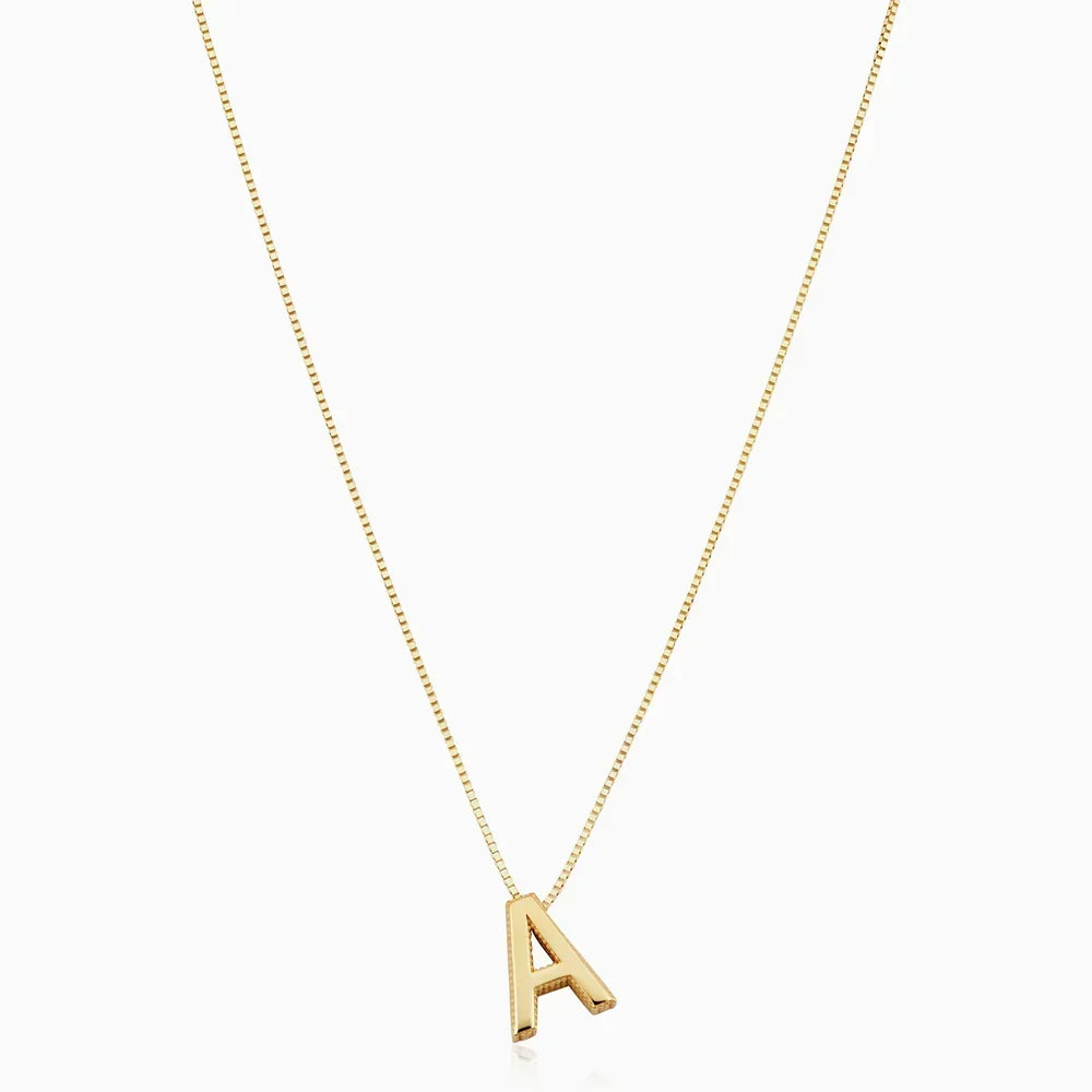 Gold initial letter necklace on a white background