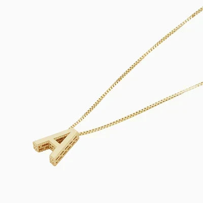 Close-up of the gold block letter pendant on a box chain